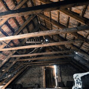 Image of unfinished attic space with signs of water damage
